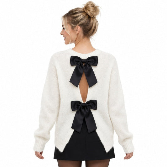 White knit jumper open back with two black satin bows on blonde model