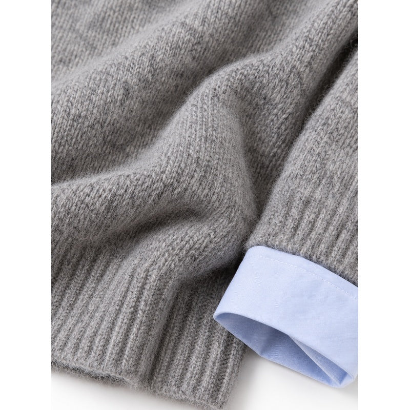 Grey sweater knit texture and pale blue shirt cuff detail