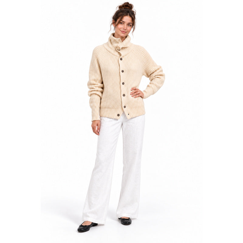 Apricot high-neck knitted cardigan with white linen trousers and black flats
