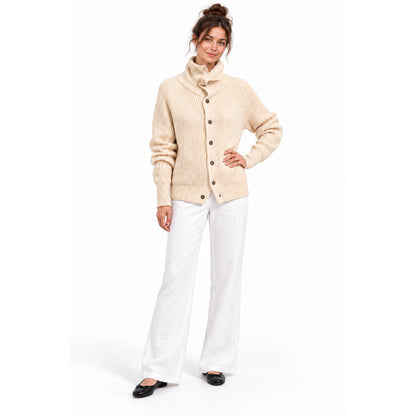 Apricot high-neck knitted cardigan with white linen trousers and black flats