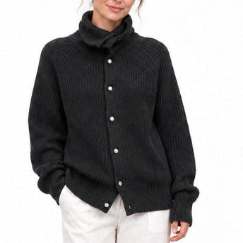 Black high-neck knitted cardigan with white linen trousers and black flats