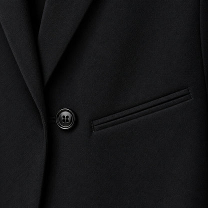 The Structured Blazer — black texture fabric close-up